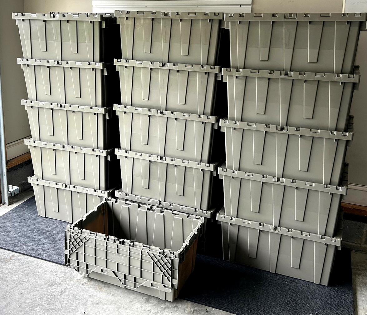 MoveTote industrial-grade 27x17x12 attached-lid moving totes stacked and ready for rental